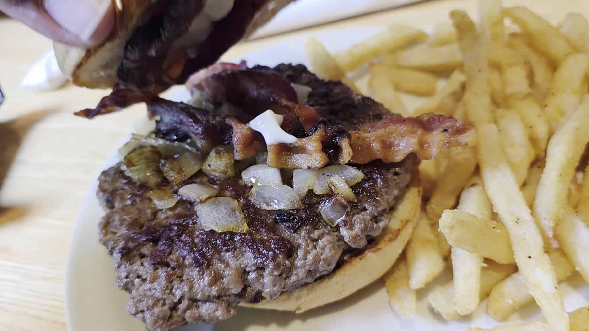 Bacon burger with fries at Schobels' Restaurant in Columbus, Texas