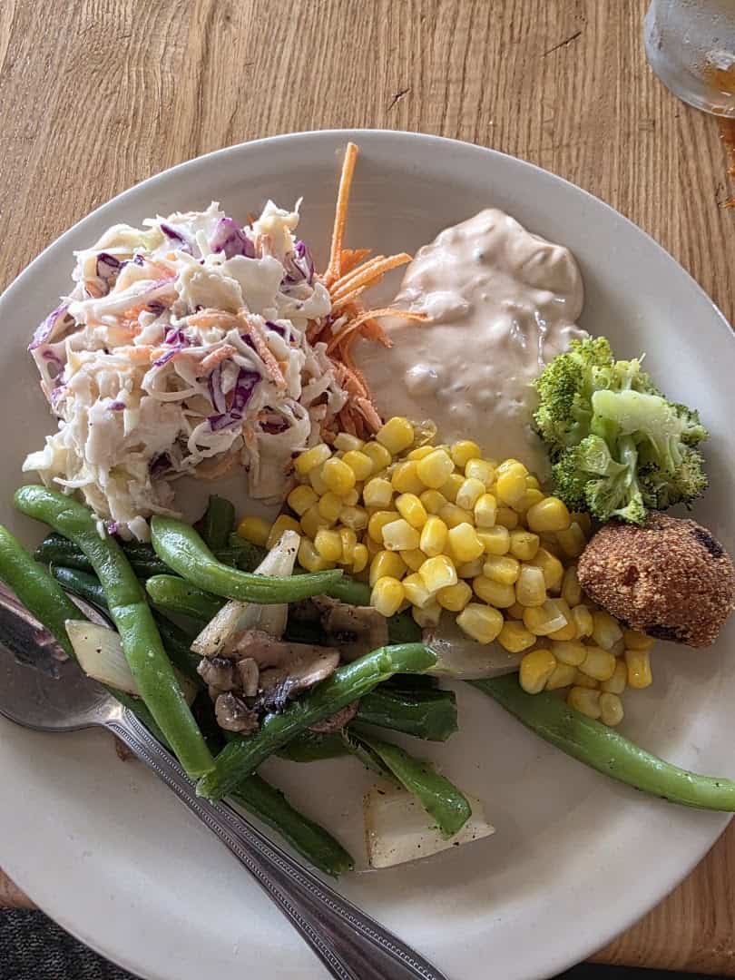 Plate of Southern vegetables with coleslaw, corn and green beans at Schobels' Restaurant in Columbus, Texas