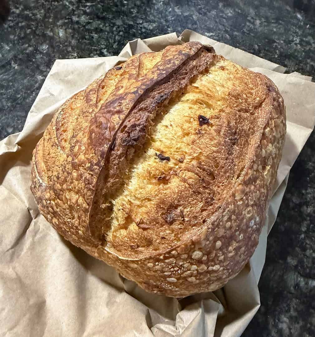A scored, crusty sourdough boule at Artisana Bread in Houston, Texas