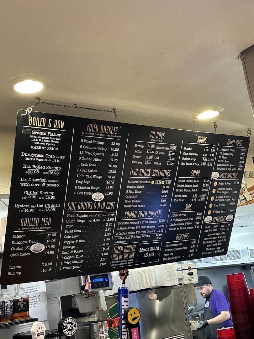 Chalkboard menu of seafood and catfish baskets at Fish Shack in Plano, Texas