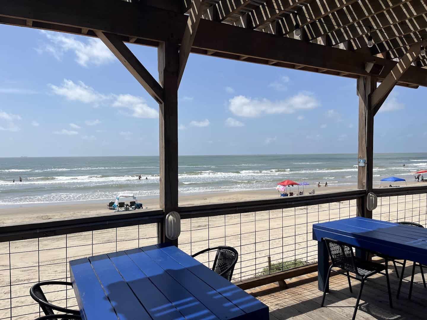 Open-air deck seating with Gulf views at Seahorse Bar & Grill in Surfside Beach, Texas