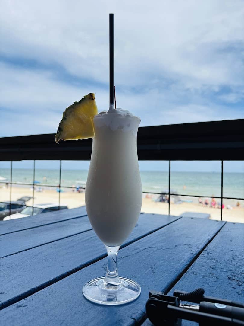Cold drink on the deck rail overlooking the Gulf at Seahorse Bar & Grill
