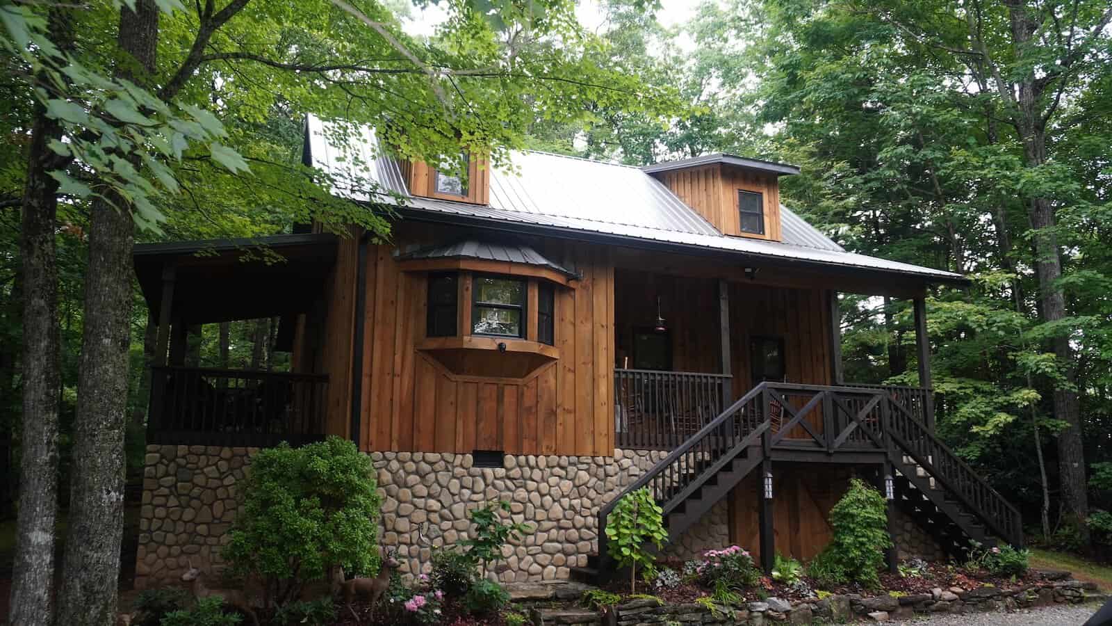 Wooden cabin with stone base in the woods at The Cabins at Seven Foxes, North Carolina