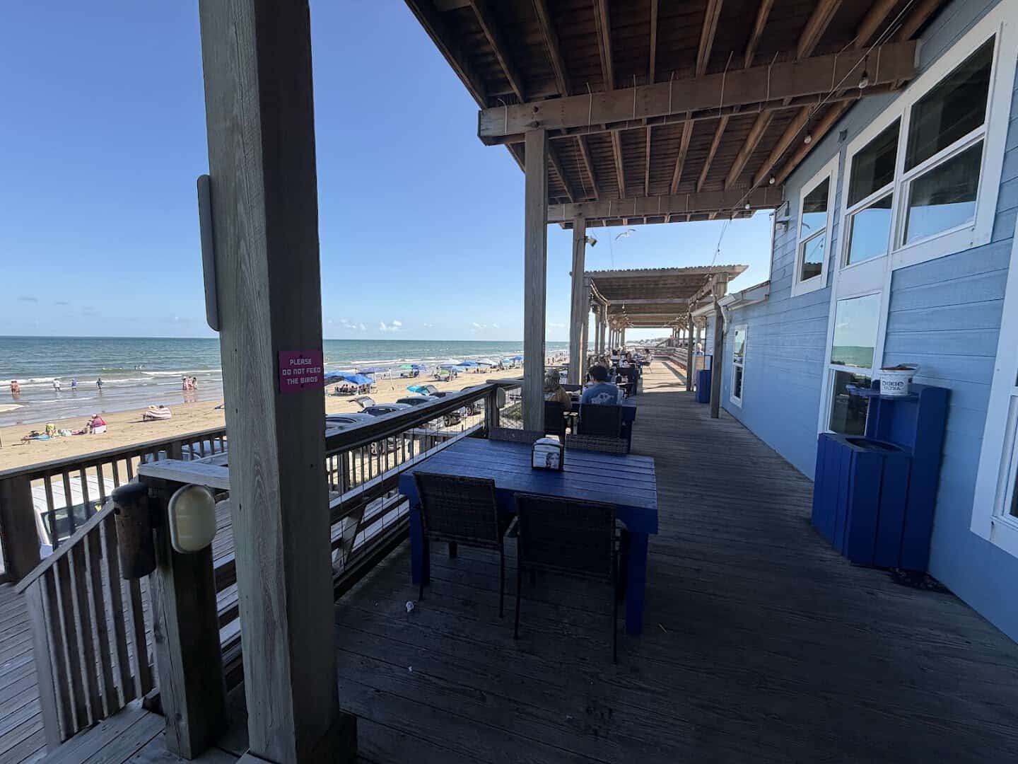 Shaded table on the deck facing the Gulf at Seahorse Bar and Grill in Surfside Beach, Texas