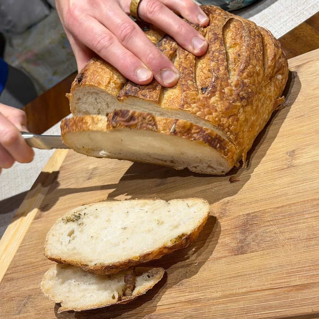 A sourdough loaf sliced to show its open crumb at Artisana Bread in Houston, Texas