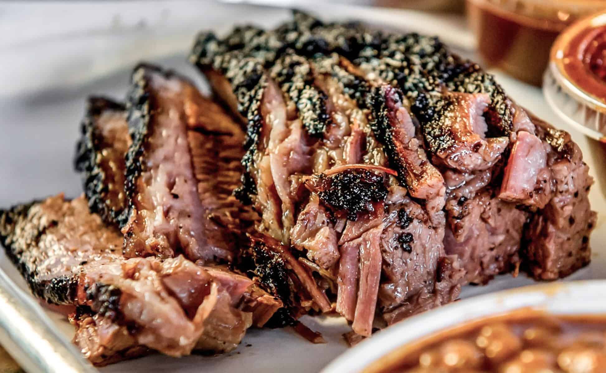 Sliced smoked brisket with beans at Smoque BBQ in Chicago, Illinois
