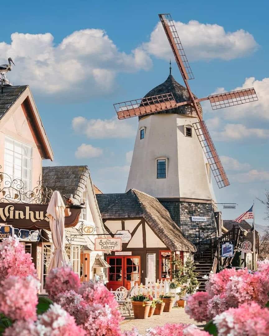 White Danish windmill and half-timbered buildings in Solvang, California