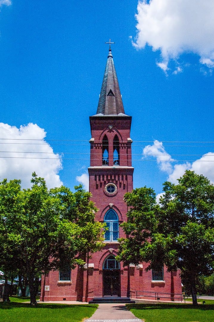 Red brick Gothic Revival exterior of St. Mary Catholic Church in High Hill, Texas