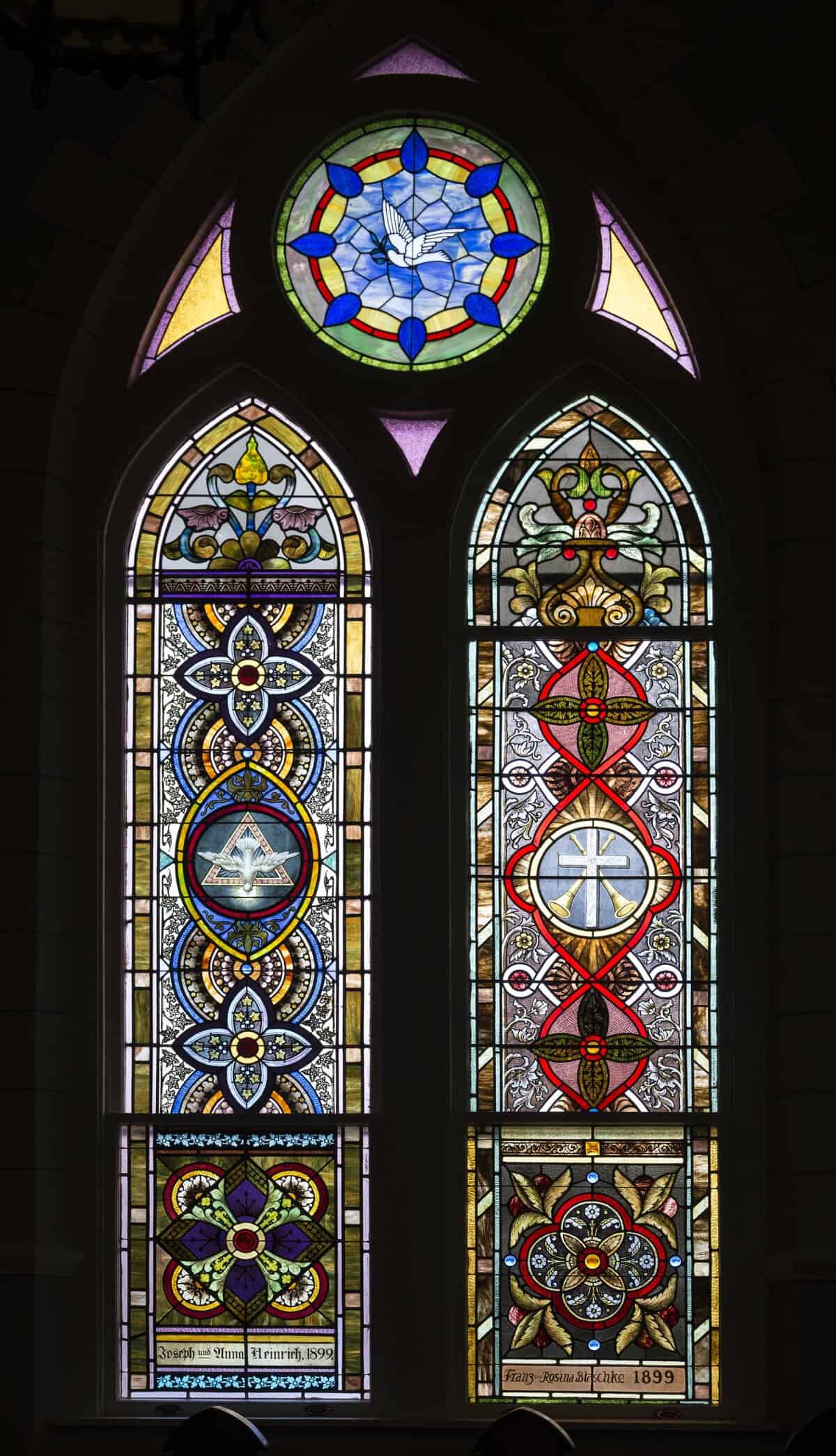 Jewel-toned stained glass window at St. Mary Catholic Church in High Hill, Texas