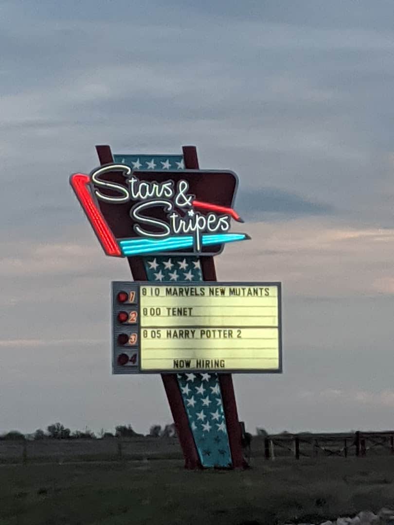 Neon Stars and Stripes marquee sign lit at dusk at the drive-in in New Braunfels, Texas