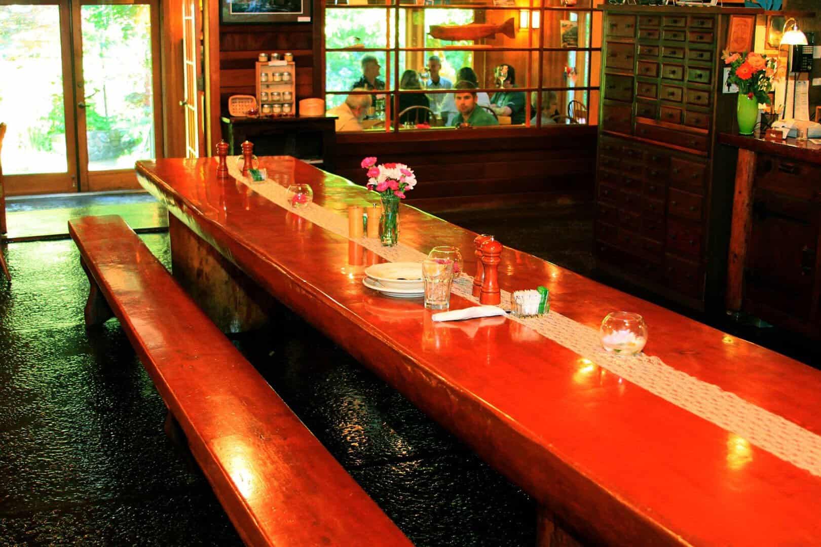 Warm wood interior with forest windows at Steamboat Inn on the North Umpqua River, Oregon