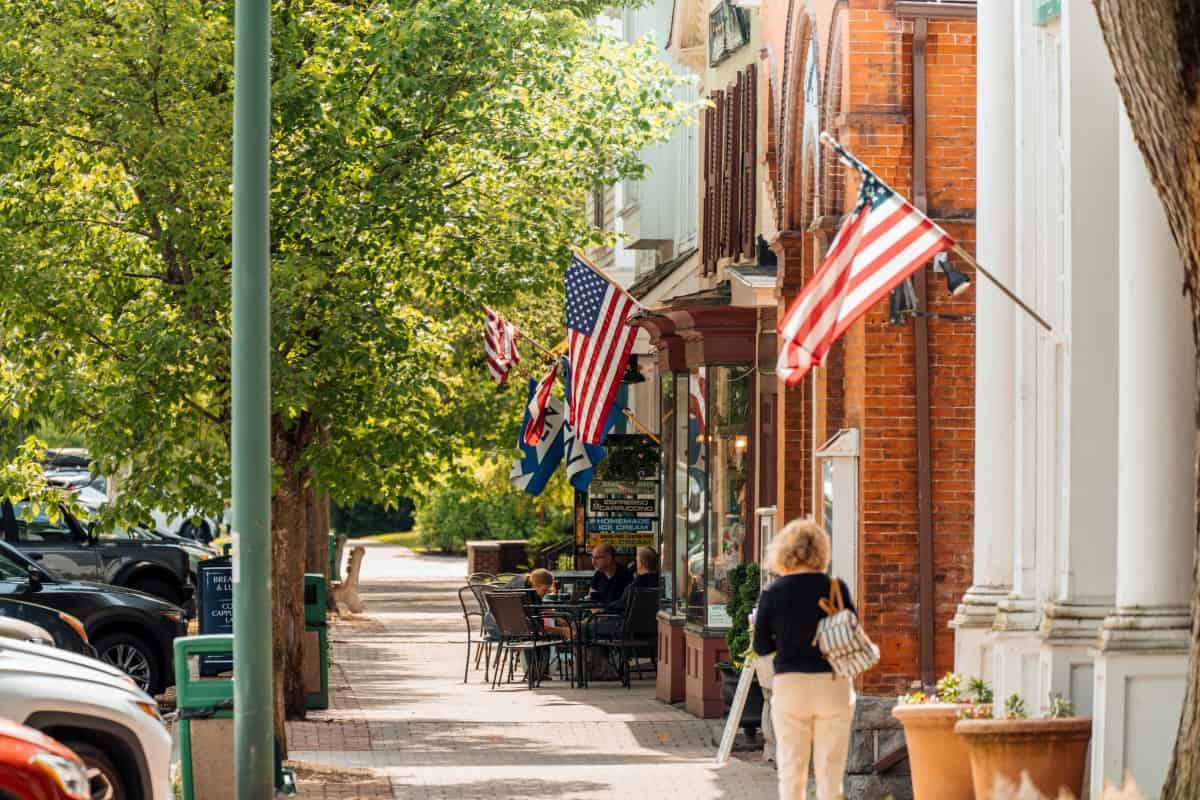 Historic Main Street storefronts with flags in Stockbridge, Massachusetts
