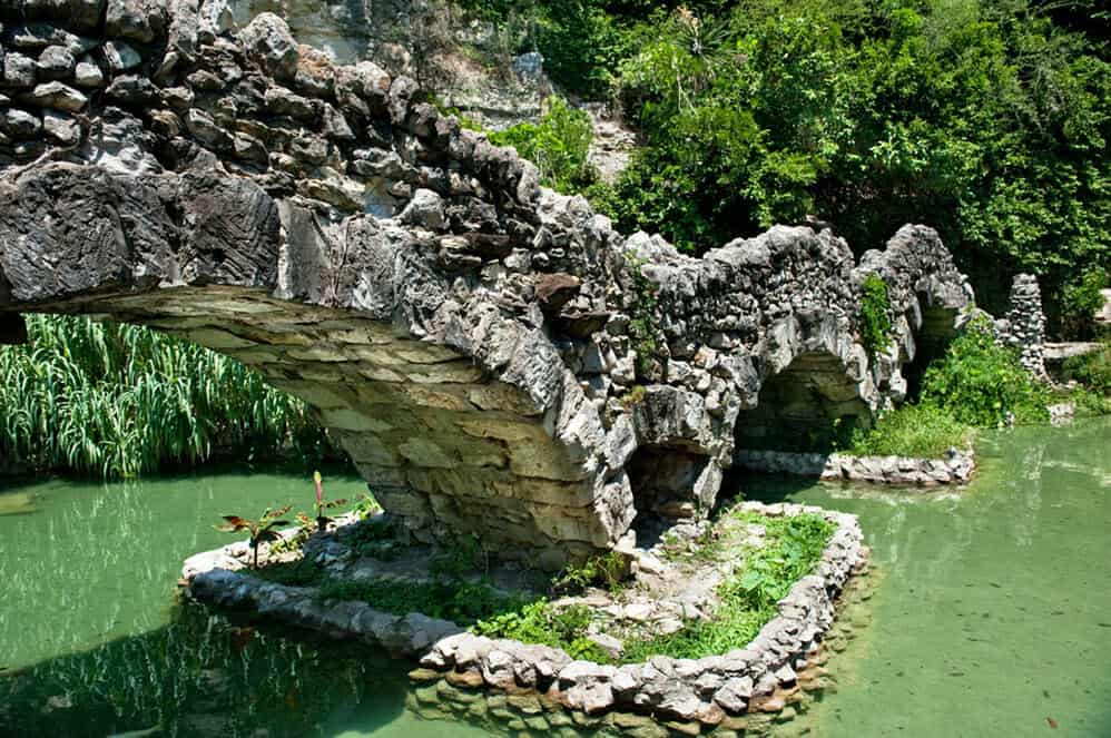 Hand-laid limestone arch bridge over the koi pond at the Japanese Tea Garden in San Antonio