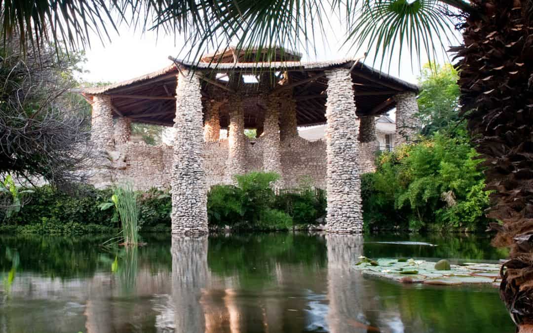 Stone pavilion reflected in the pond at the Japanese Tea Garden in San Antonio