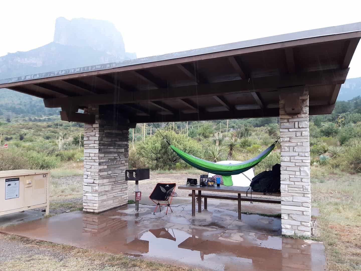 Stone-pillared picnic shelter and food storage locker at a Chisos Basin campsite