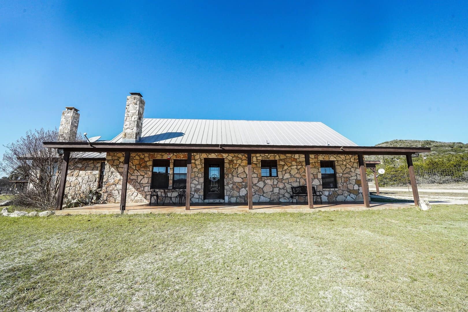 A stone river cabin among the trees near the Frio River in Concan, Texas