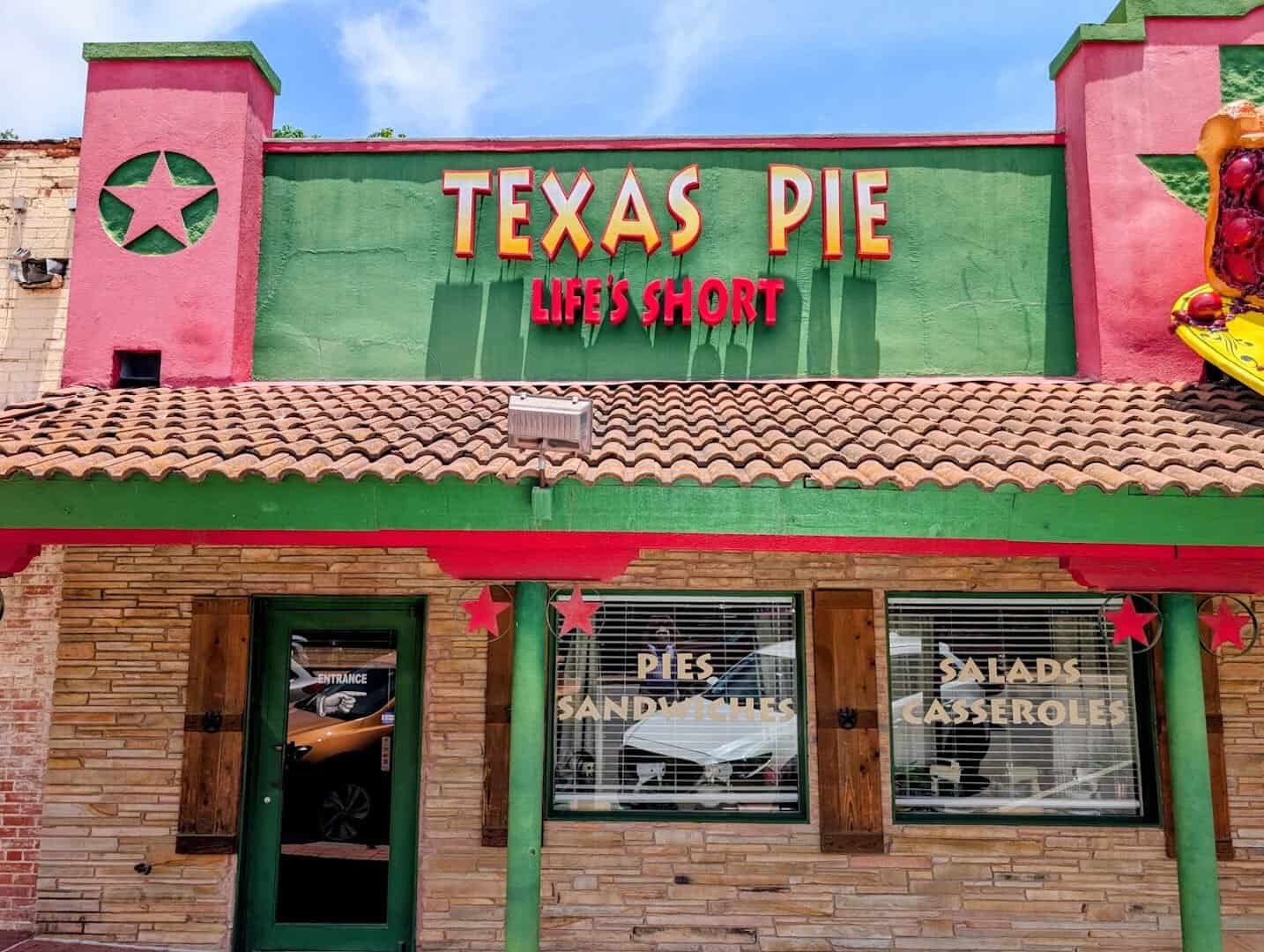 Green and pink painted storefront of Texas Pie Company in Kyle, Texas