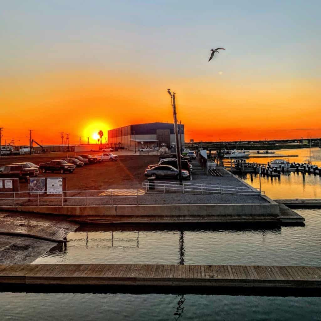 Sunset over the dock and Aransas Bay at Paradise Key in Rockport, Texas