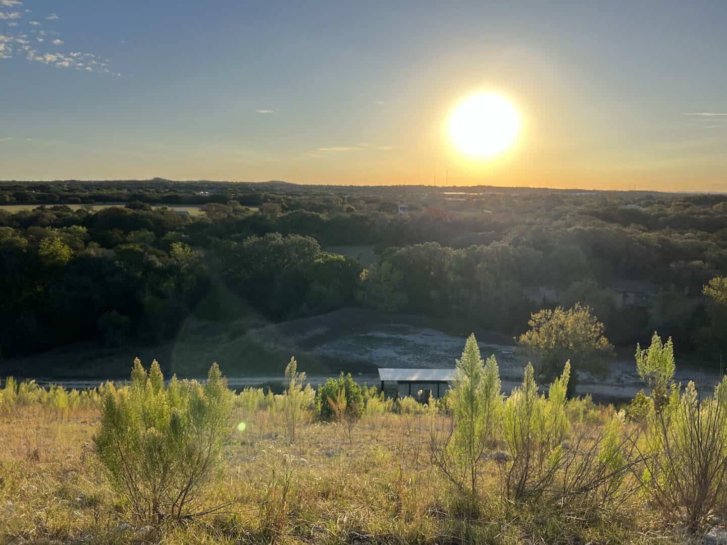 Sunset over the open scrub and hills of Boerne City Lake Park in Kendall County, Texas