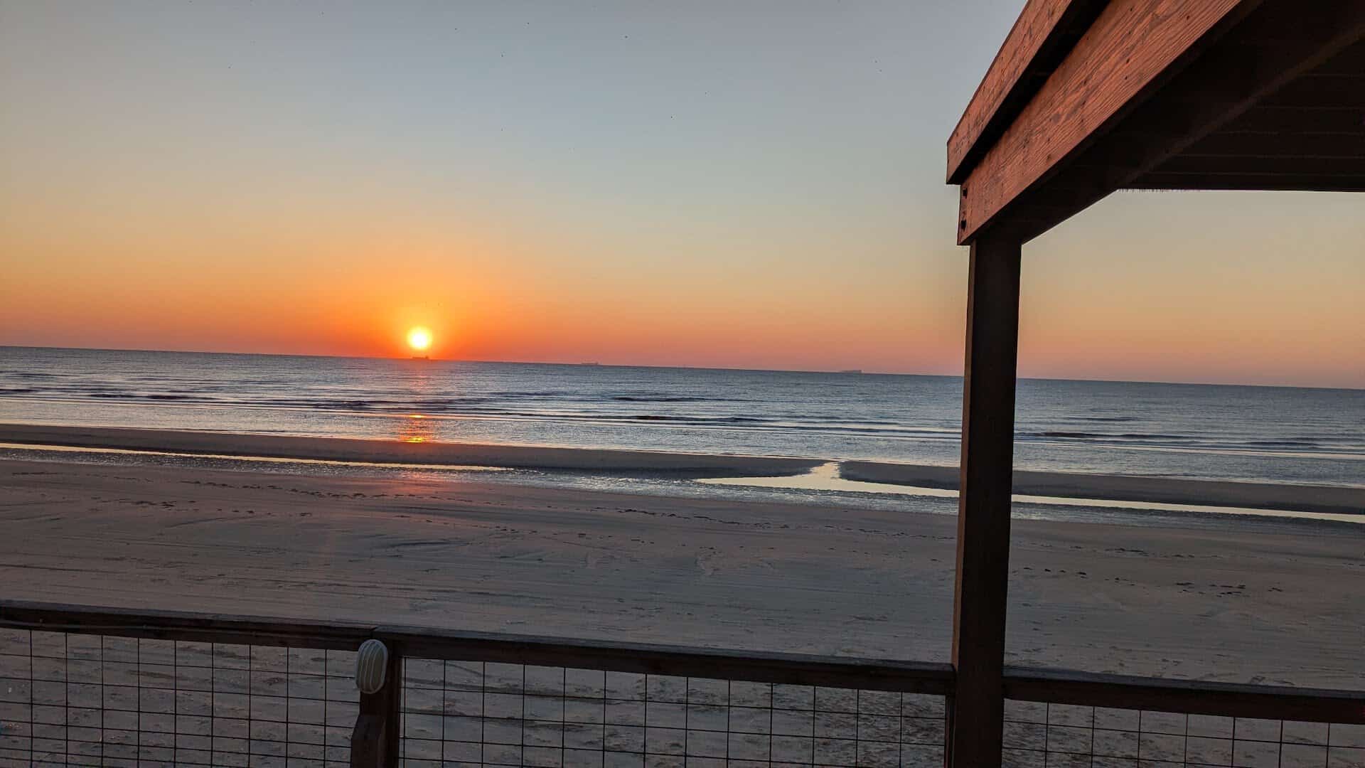 Sunset over the Gulf seen from the deck at Seahorse Bar and Grill in Surfside Beach, Texas