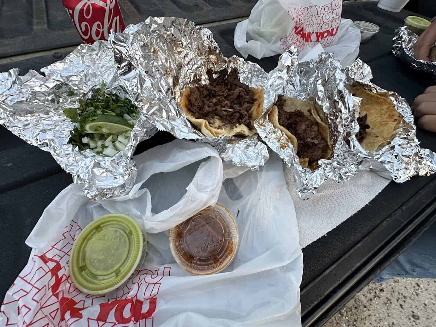 A spread of tacos, salsas and a drink at El Taconazo in Houston