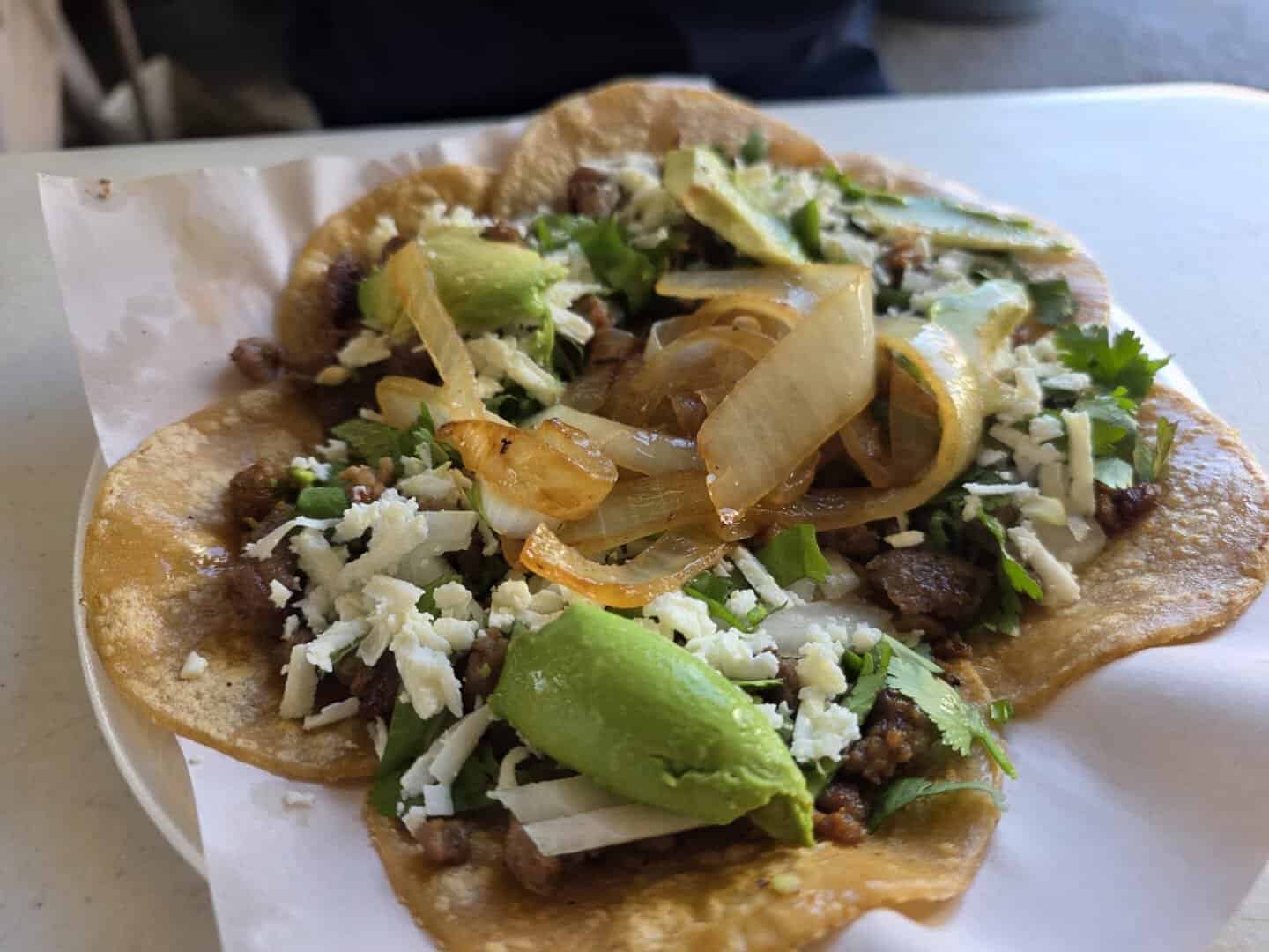 Plate of tacos with avocado from a food vendor at 77 Flea Market in Brownsville, Texas