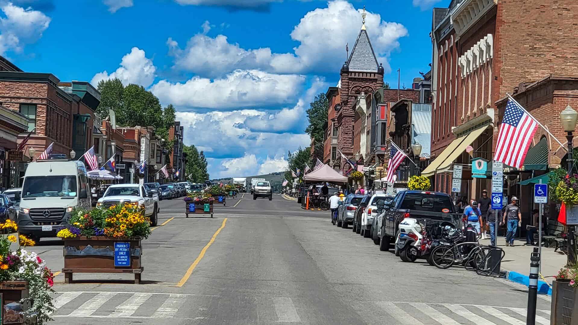 Colorado Avenue lined with historic storefronts and mountains in Telluride, Colorado