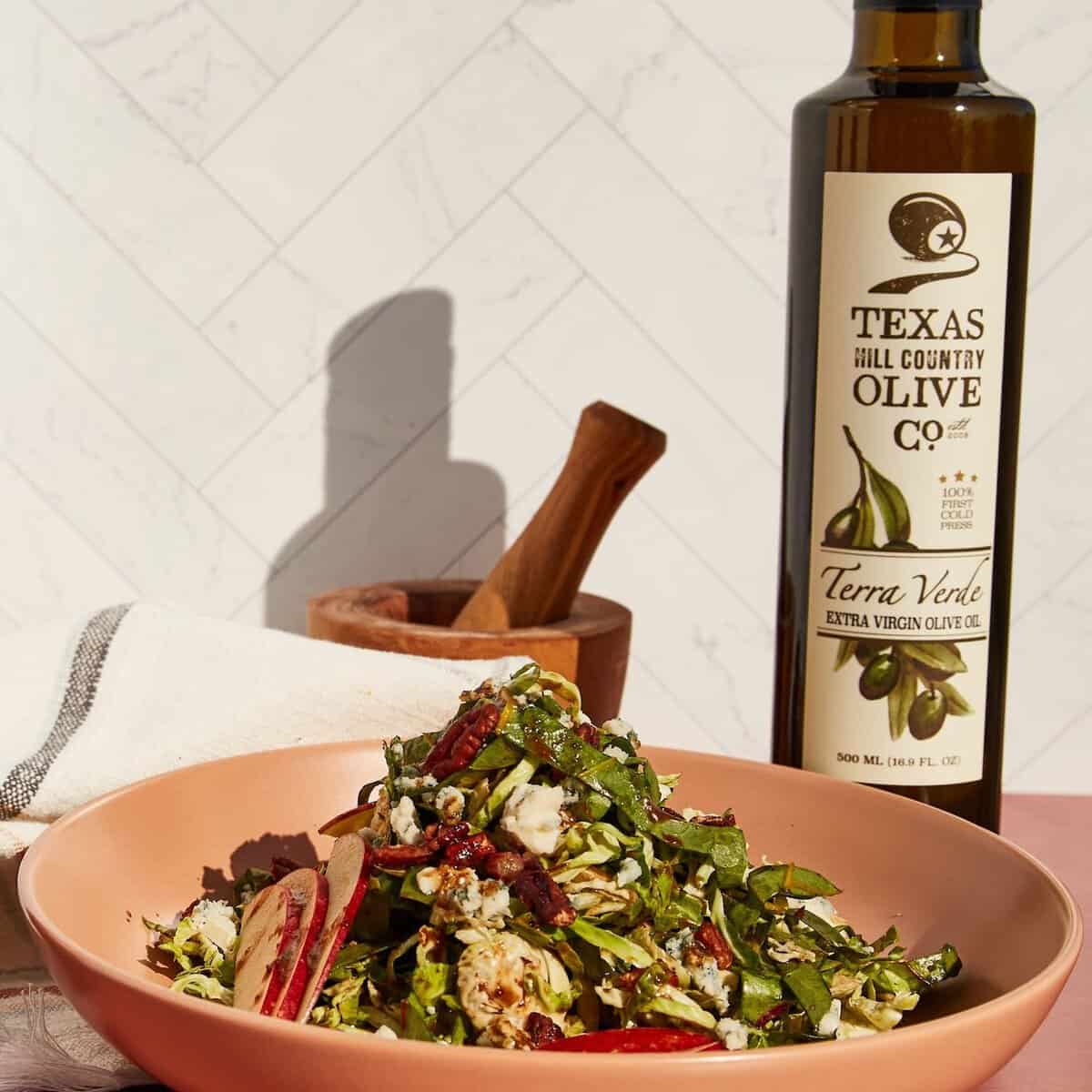 Fall salad dressed with Texas Hill Country Terra Verde extra virgin olive oil