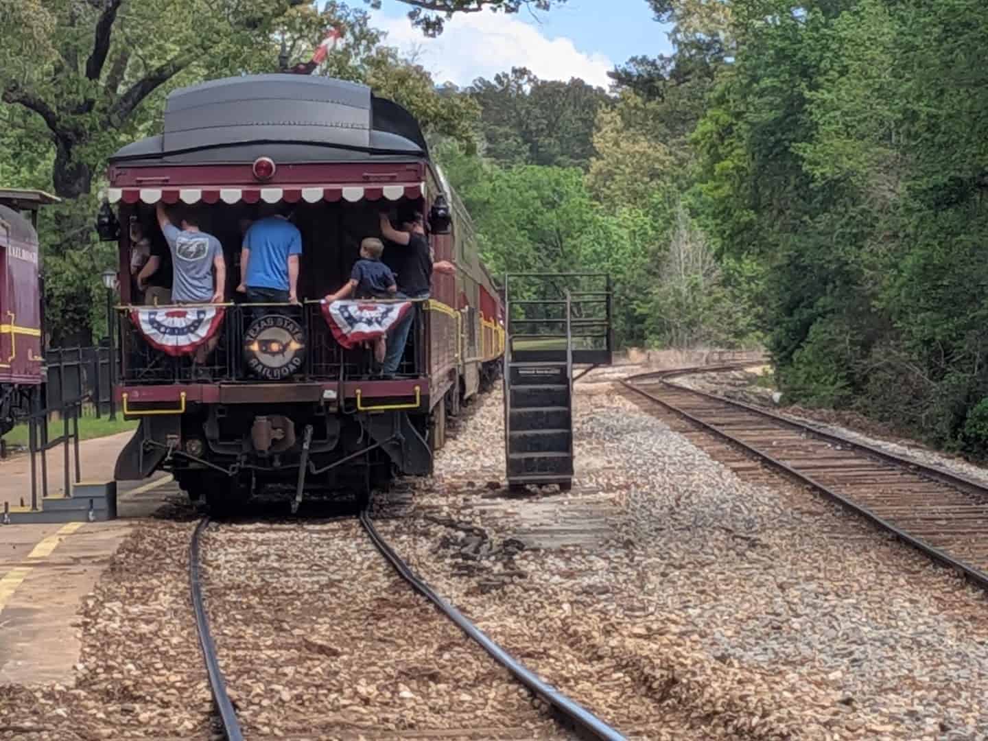 Vintage Texas State Railroad train coming down the line through East Texas pines