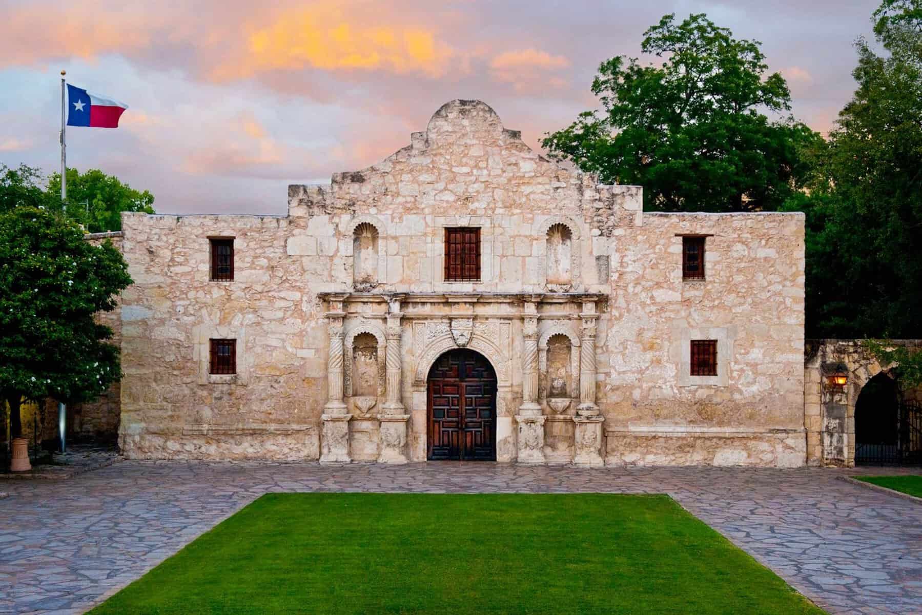 The historic Alamo mission church facade at dusk in San Antonio, Texas
