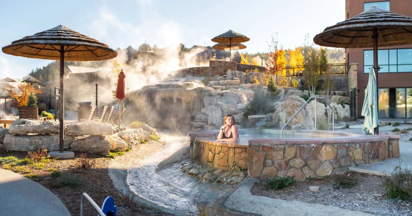 Terraced riverside soaking pools with steam at The Springs Resort in Pagosa Springs, Colorado