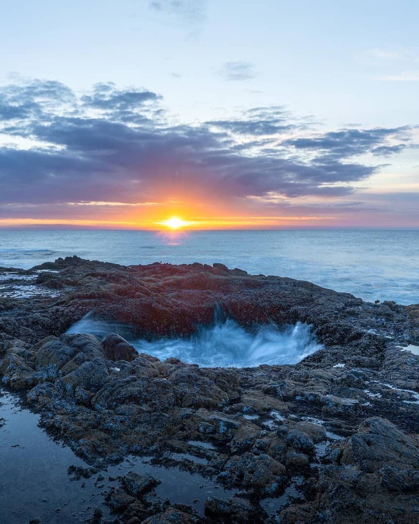 Seawater draining into Thor's Well at sunset on the Oregon coast near Yachats