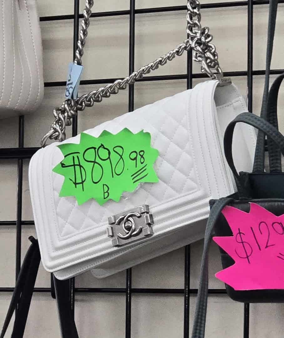 Designer handbag with colored price tags at Thrift Giant in Dallas