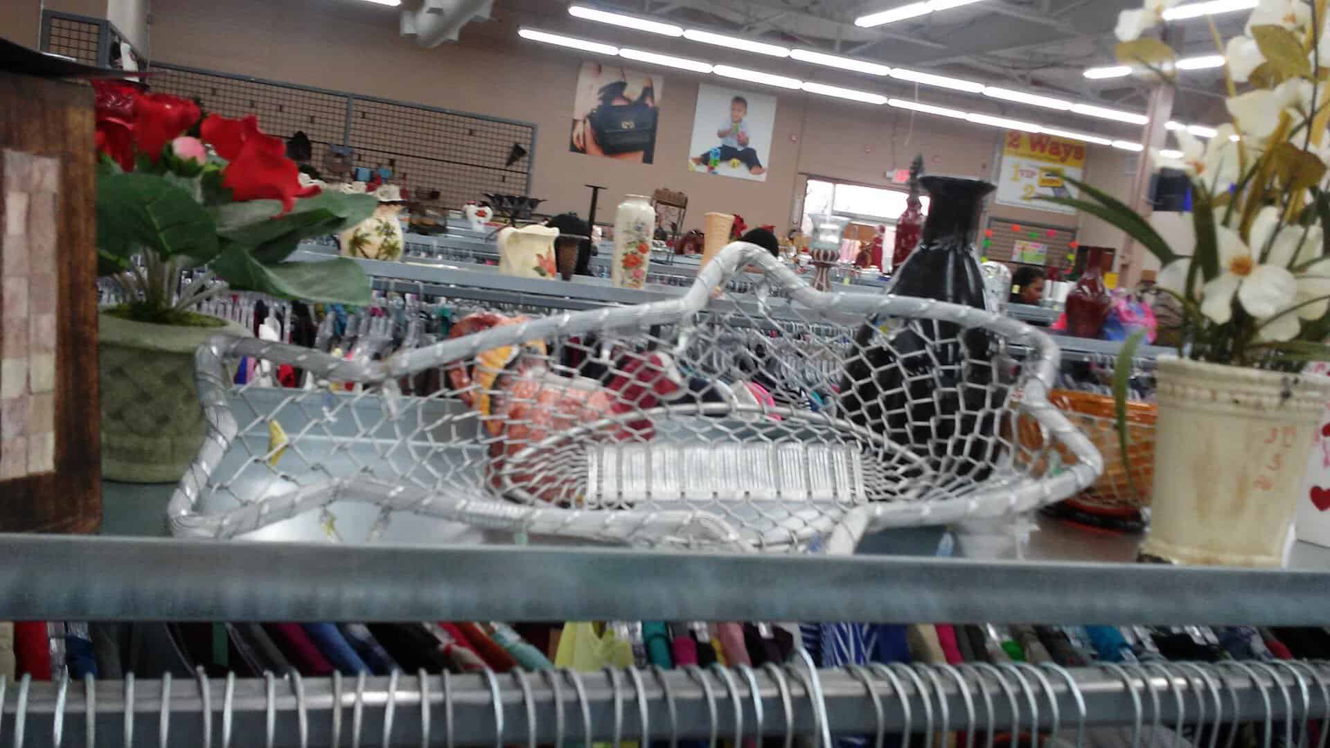 Home decor display beside clothing racks at Thrift Giant in Dallas