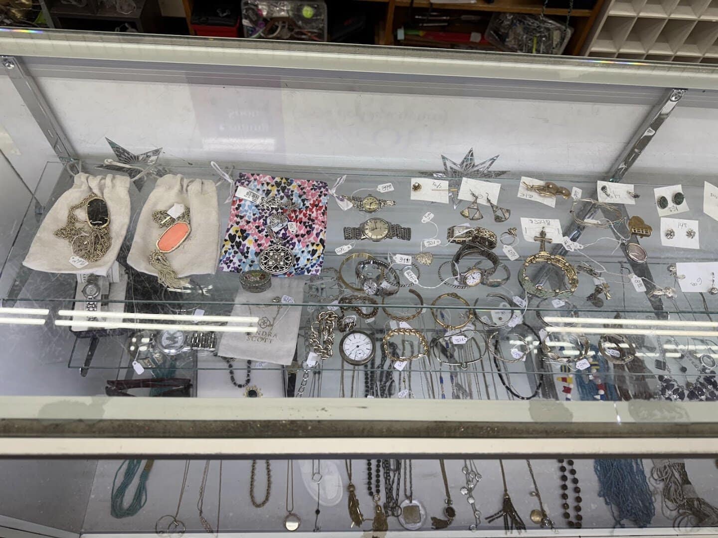 Glass case of jewelry and watches at Thrift Giant in Dallas