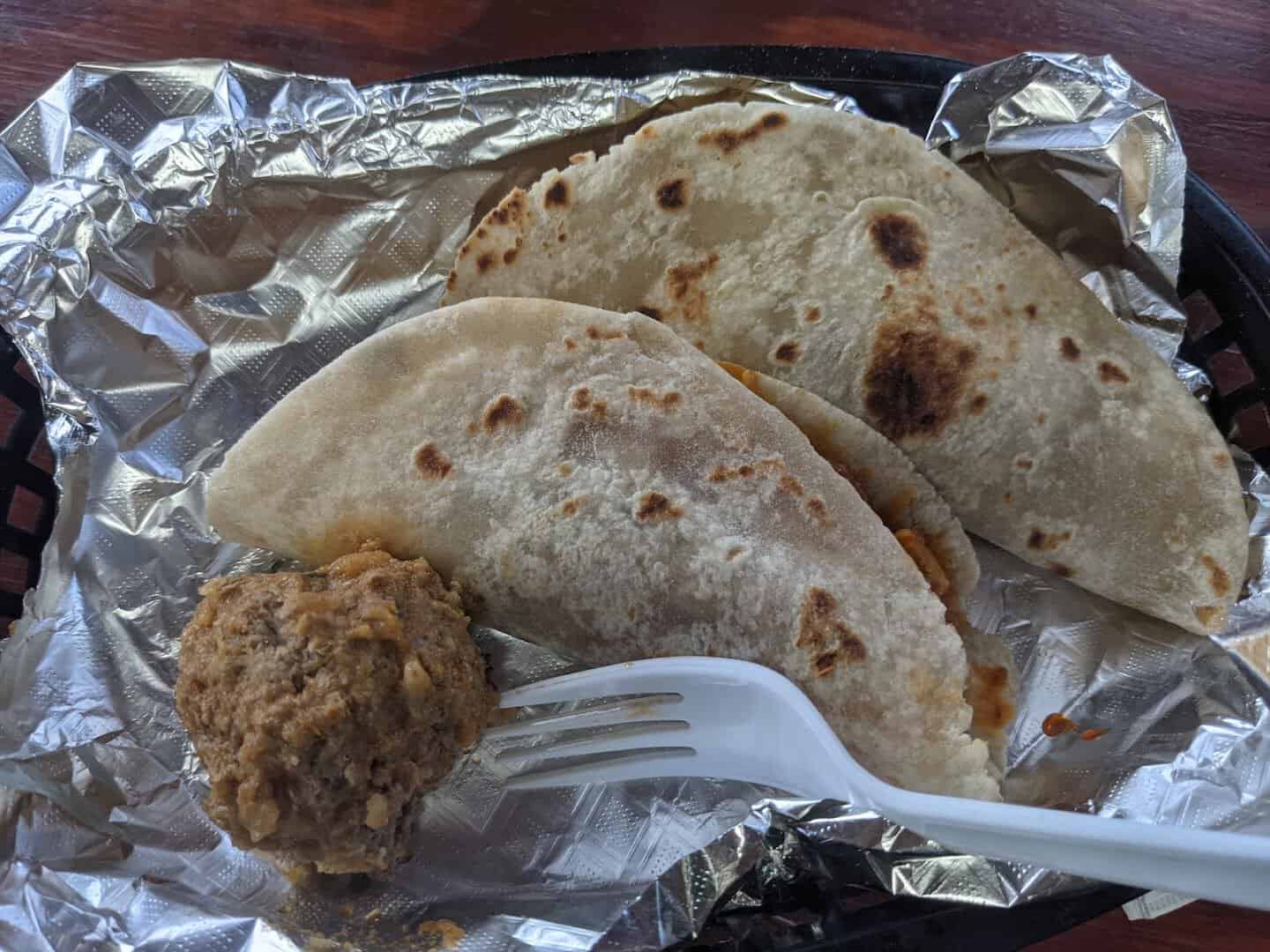 Warm handmade flour tortillas with barbacoa at Titas Taco House in Humble, Texas