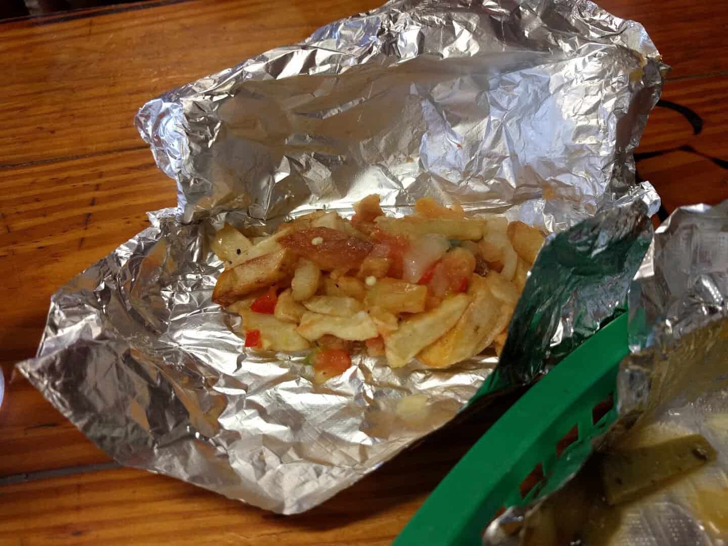 A breakfast taco wrapped in foil at Titas Taco House in Humble, Texas