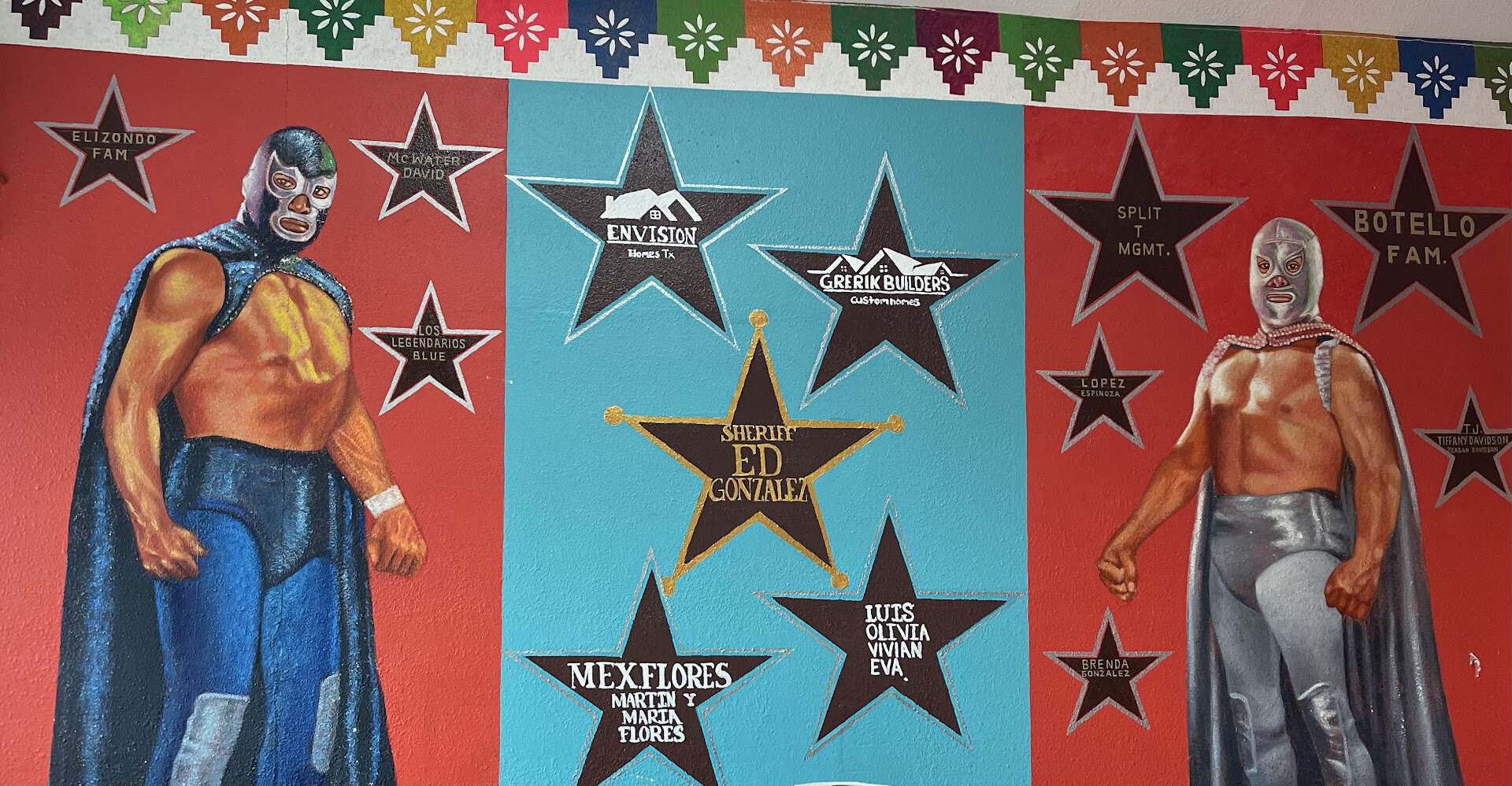 A painted luchador mural inside Titas Taco House in Humble, Texas