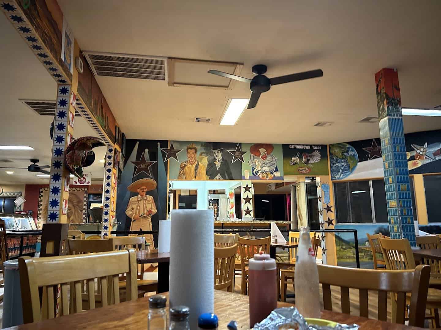 The mural-covered dining room inside Titas Taco House in Humble, Texas