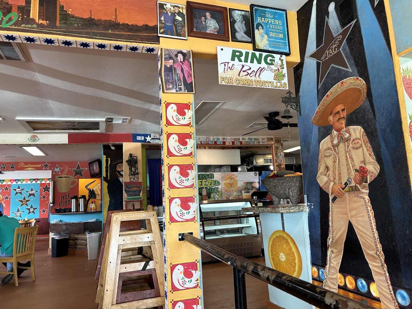 The ring-the-bell sign for fresh corn tortillas at Titas Taco House in Humble, Texas