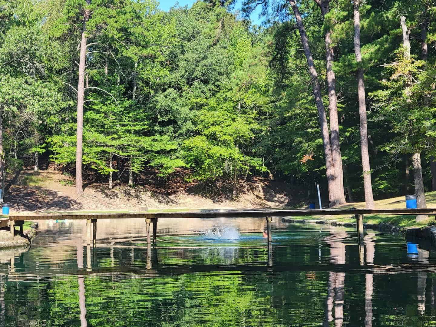 Dock over the clear spring water at Camp Tonkawa Springs, Texas