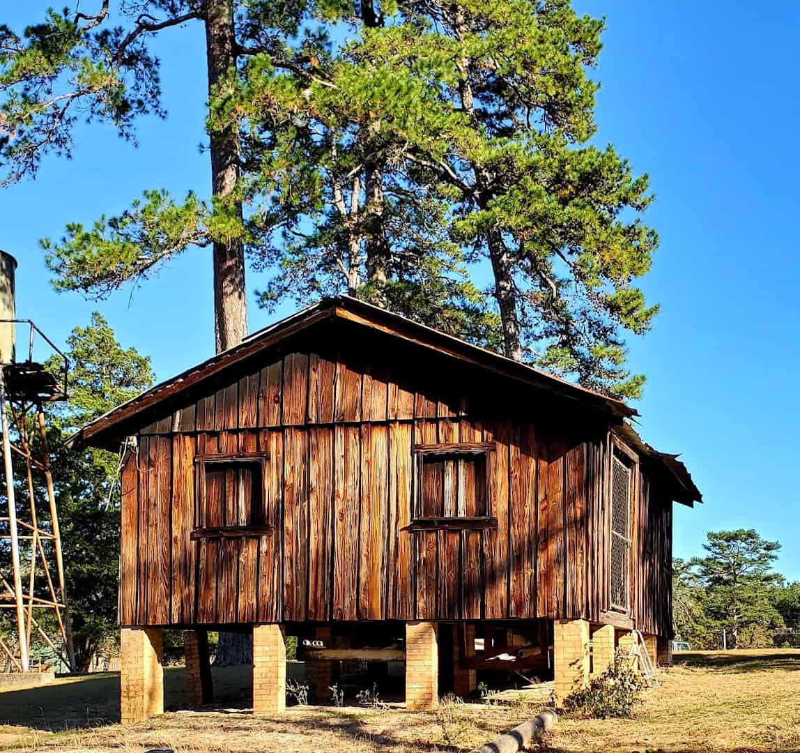 Historic wooden mill building at Camp Tonkawa Springs in Garrison, Texas