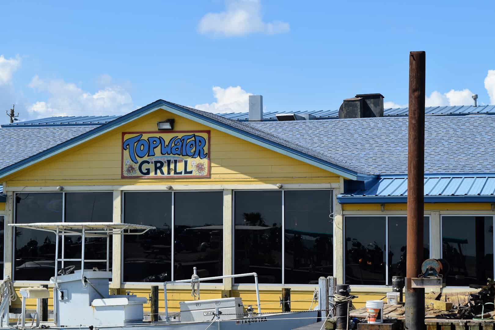 The Topwater Grill building and sign on the waterfront in San Leon, Texas