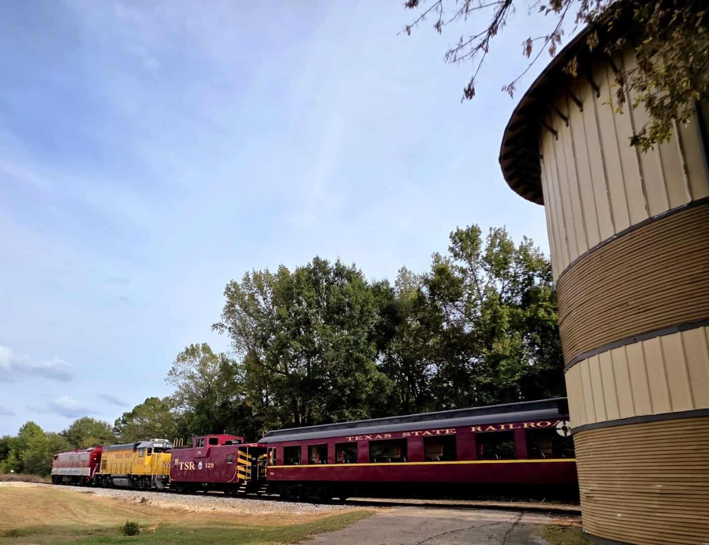 Texas State Railroad passenger train curving through the East Texas woods