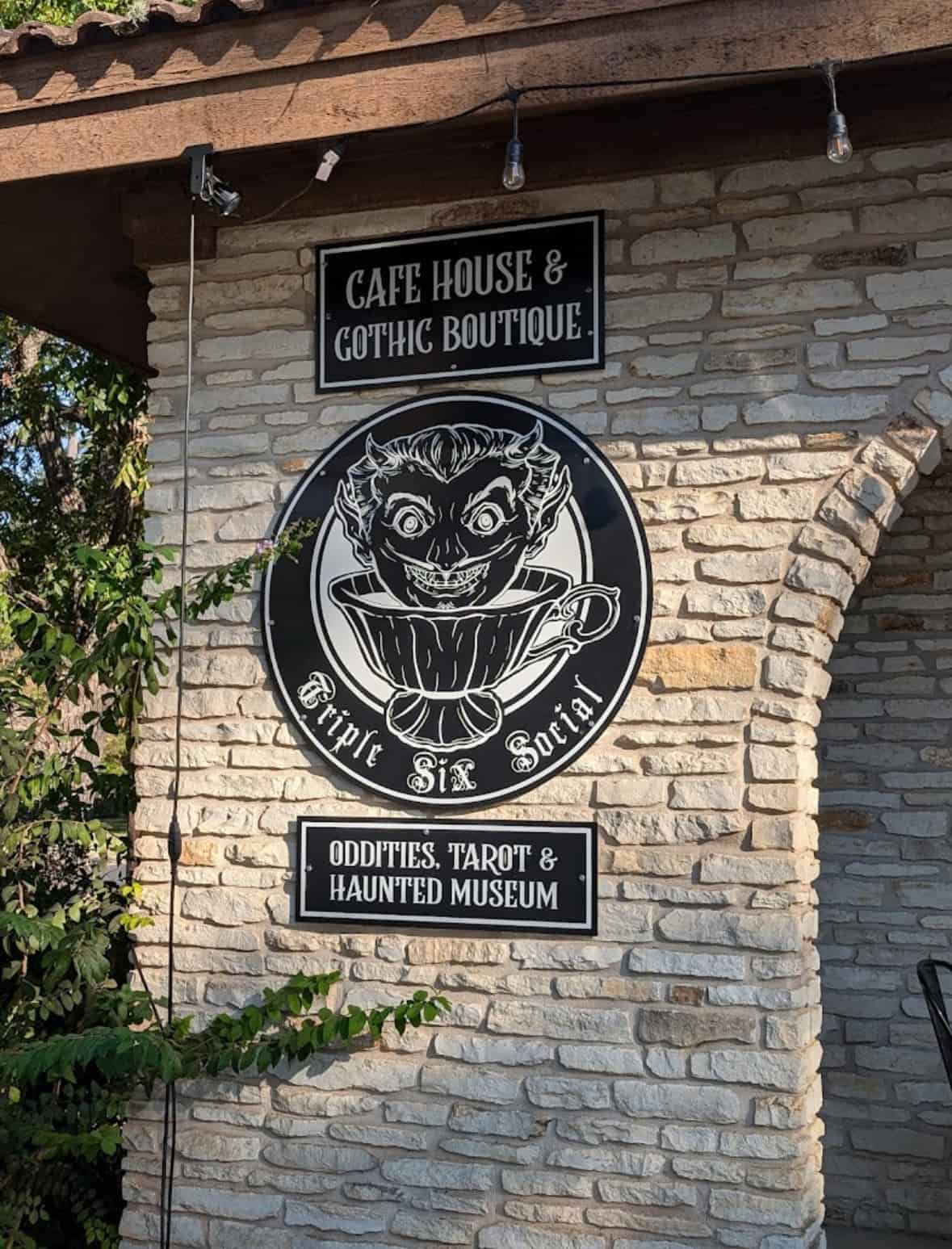 Exterior sign for Triple Six Social cafe house and gothic boutique in San Marcos