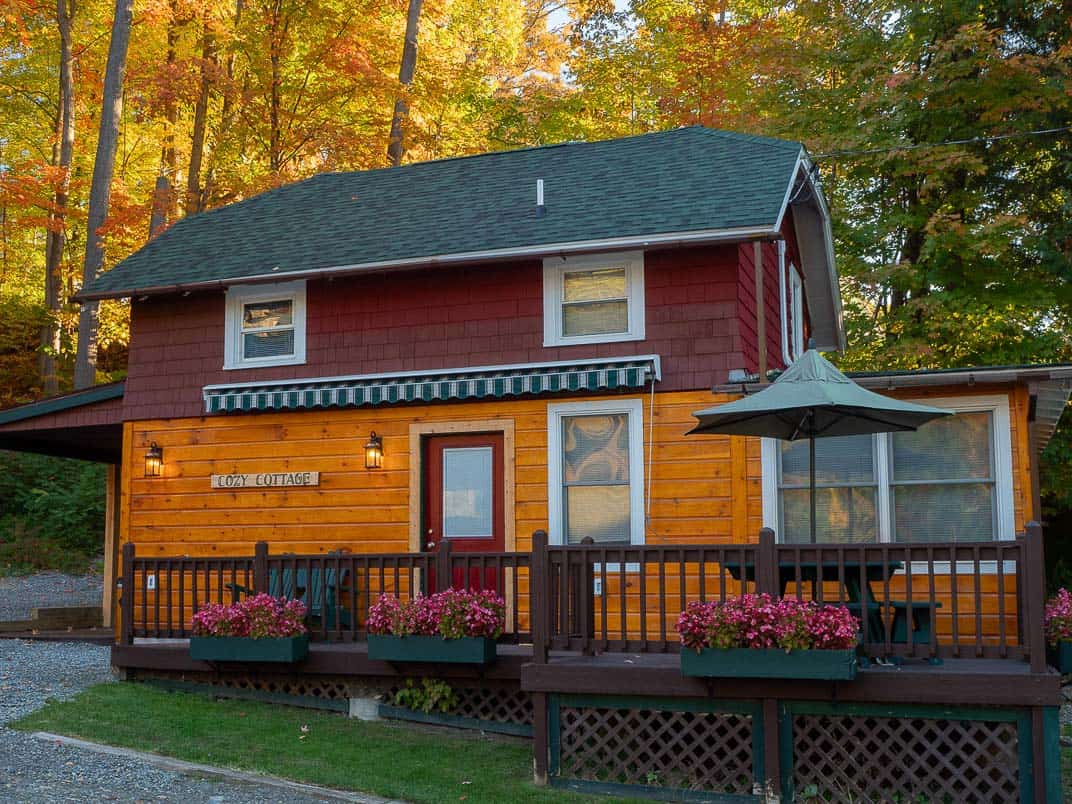 Lakefront cabin with fall foliage at Trout House Village Resort on Lake George, New York