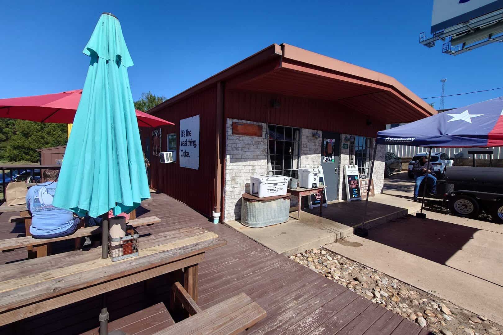 Covered picnic-table seating at Truth Barbeque in Brenham, Texas