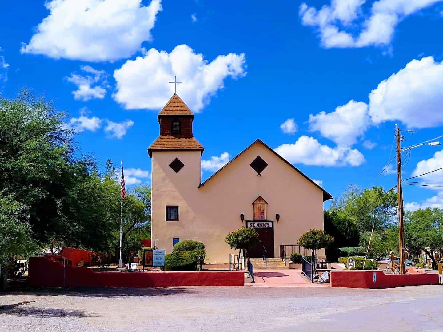 Historic adobe church against desert sky in Tubac, Arizona
