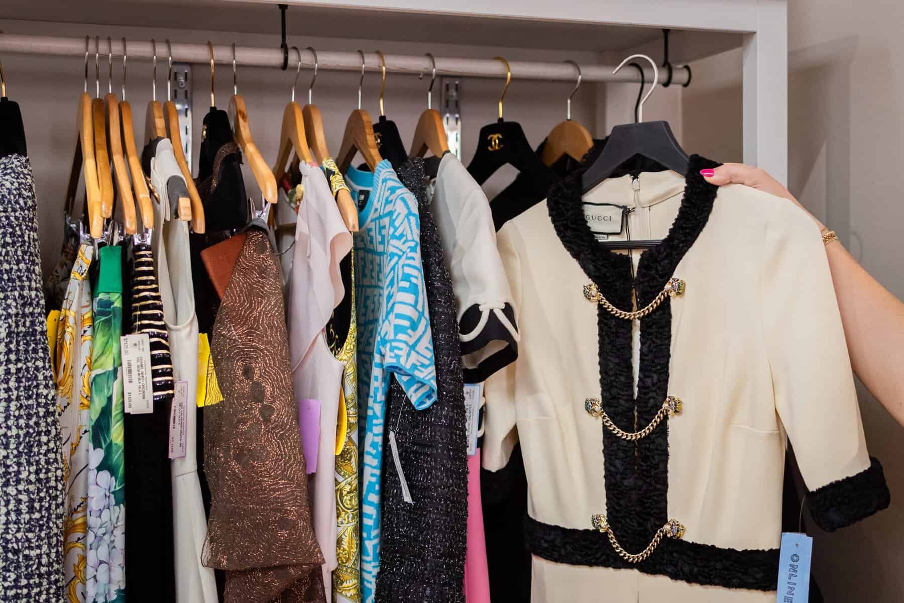 A tweed designer jacket on a crowded clothing rack at Clotheshorse Anonymous in Dallas