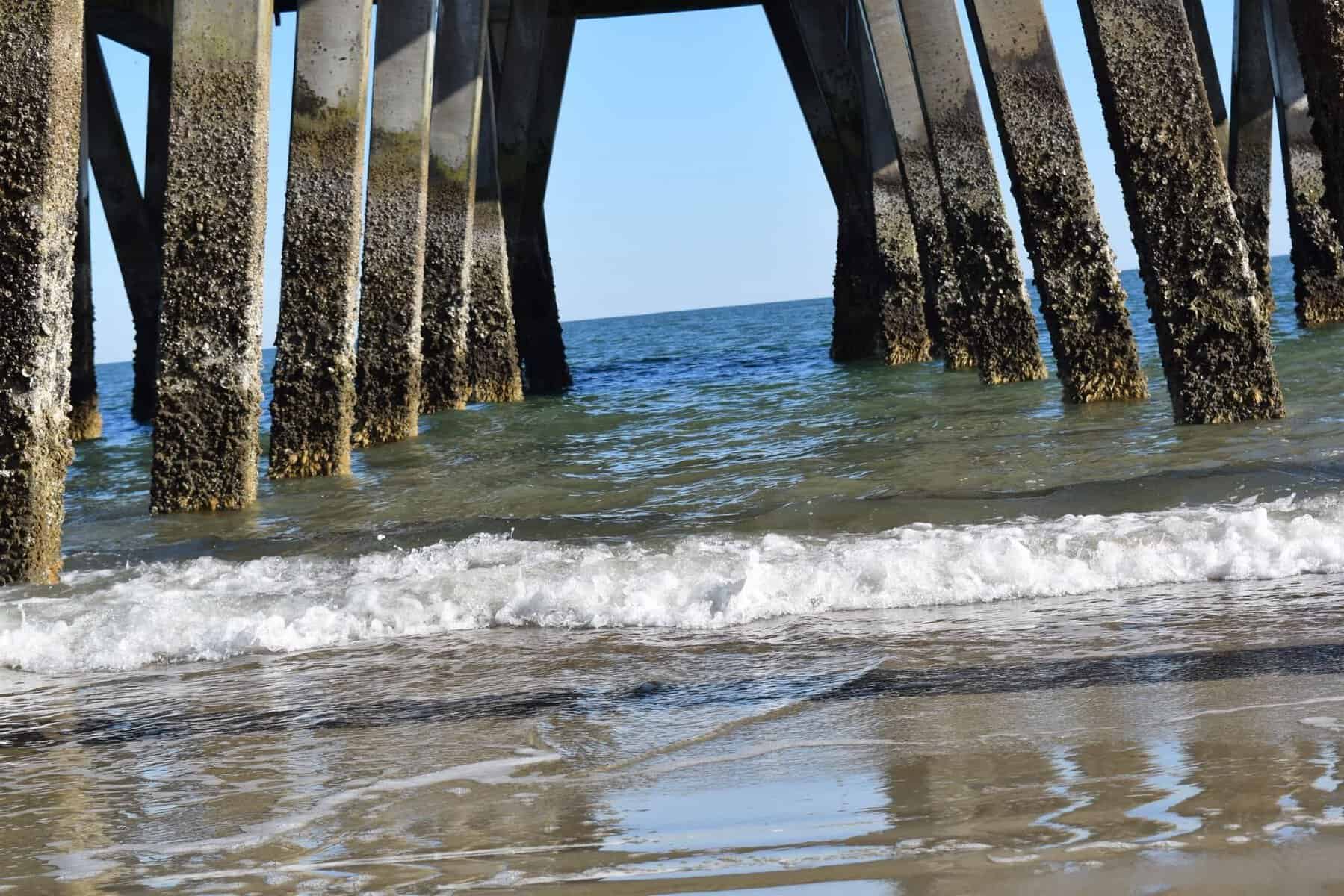 Surf washing under the Tybee Pier on Tybee Island, Georgia